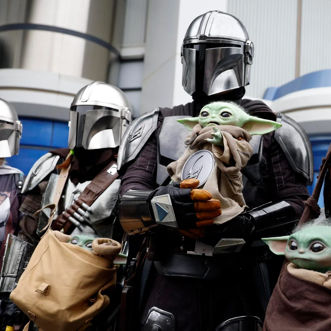 Ahead of the release of the latest Star Wars movie The Mandalorian and Grogu, guests dressed in costumes inspired by the characters pose in front of Star Tours: The Adventures Continue at Tokyo Disneyland in Japan on April 23, 2026. 