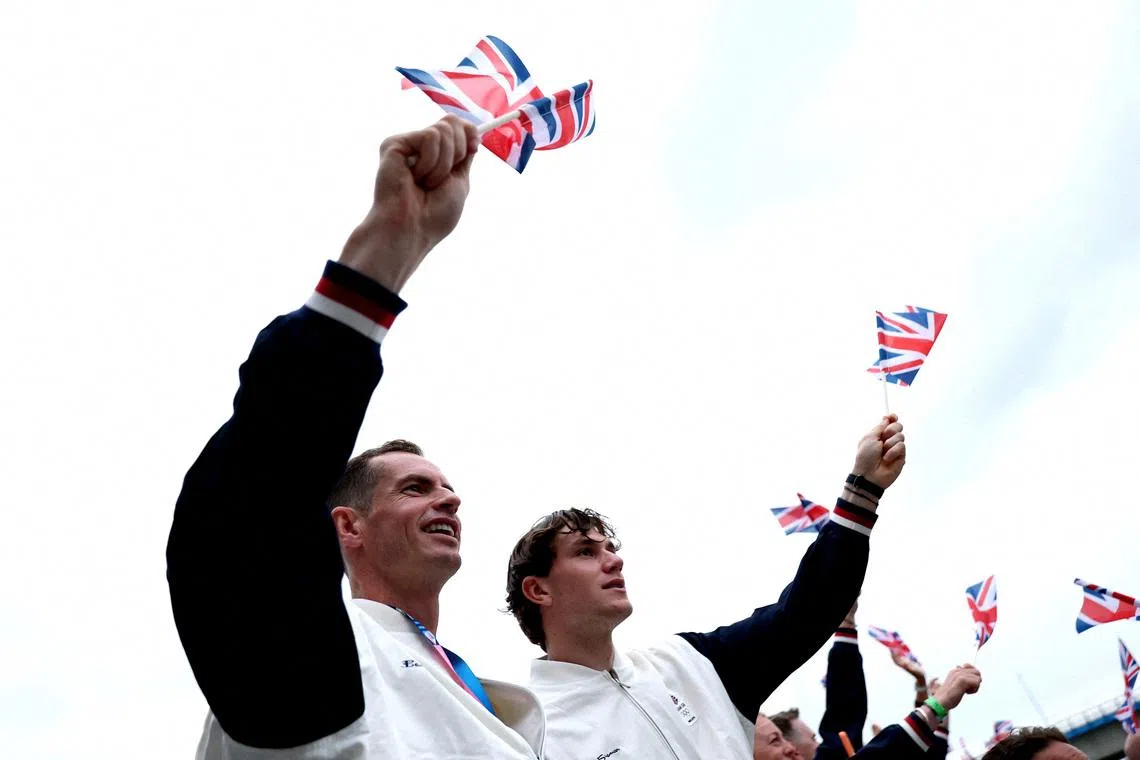 FILE PHOTO: Paris 2024 Olympics - Opening Ceremony - Paris, France - July 26, 2024. Tennis players, Andy Murray and Jack Draper of Britain wave flags on the team boat during the opening ceremony of the Olympic Games Paris 2024.     Naomi Baker/Pool via REUTERS/File Photo