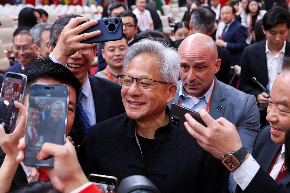 Nvidia CEO Jensen Huang is surrounded by media members after the opening ceremony for the China International Supply Chain Expo in Beijing, China July 16, 2025. REUTERS/Florence Lo