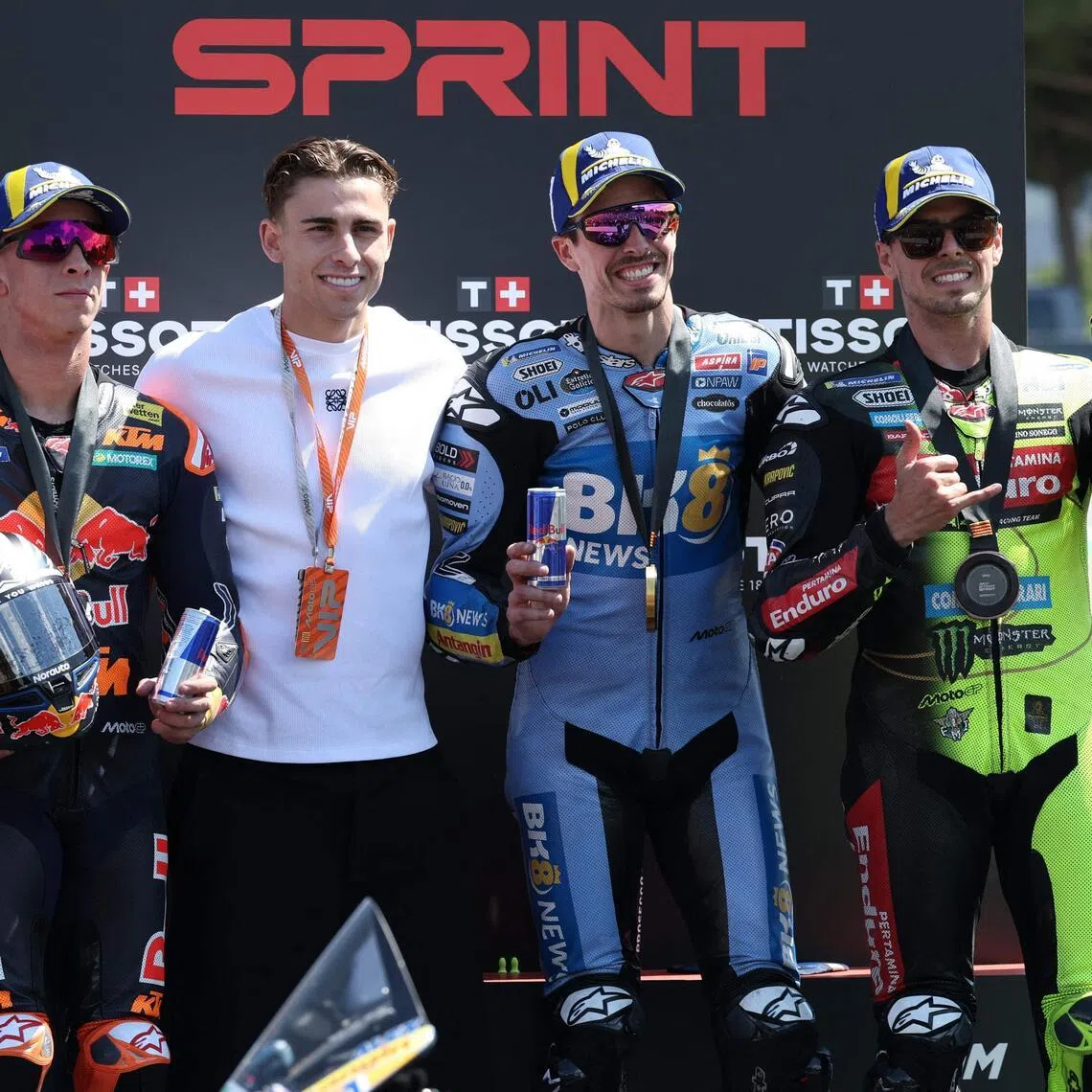 Second-placed KTM's Pedro Acosta (left), winner Gresini Racing's Alex Marquez (second from right) and third-placed VR46 Racing's Fabio di Giannantonio (right) on the podium with Barcelona's Spanish midfielder Fermin Lopez, after the sprint race at the Catalunya MotoGP Grand Prix in Montmelo, near Barcelona, on May 16, 2026.