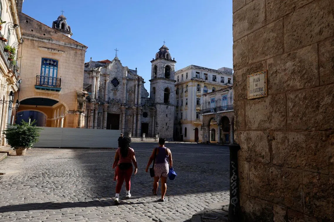 Women walk through Cathedral Square, one of the most popular tourist spots in Old Havana, as U.S. sanctions have led most major tourism and travel companies to leave the island or drastically scale back their operations, in Havana, Cuba June 8, 2026. REUTERS/Norlys Perez