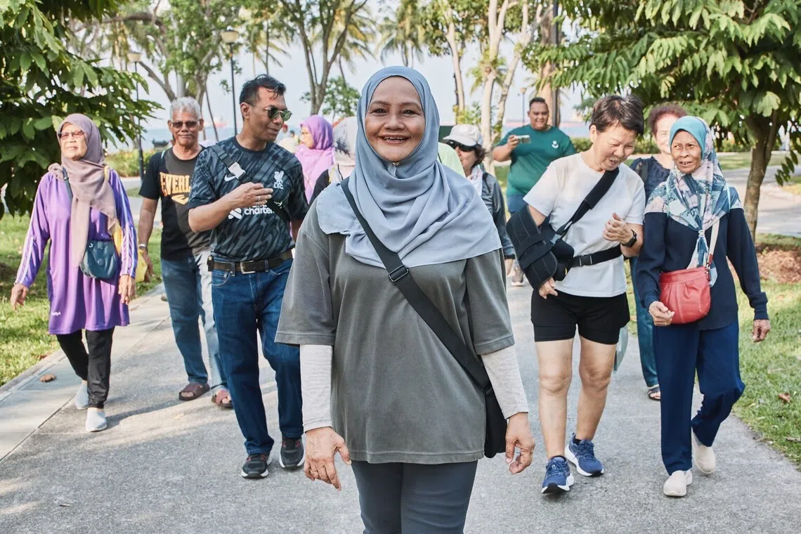 Madam Safeah Bee Abul Kayum (centre) has found a community with fellow residents in Marine Parade, participating in brisk walks and other activities together. 