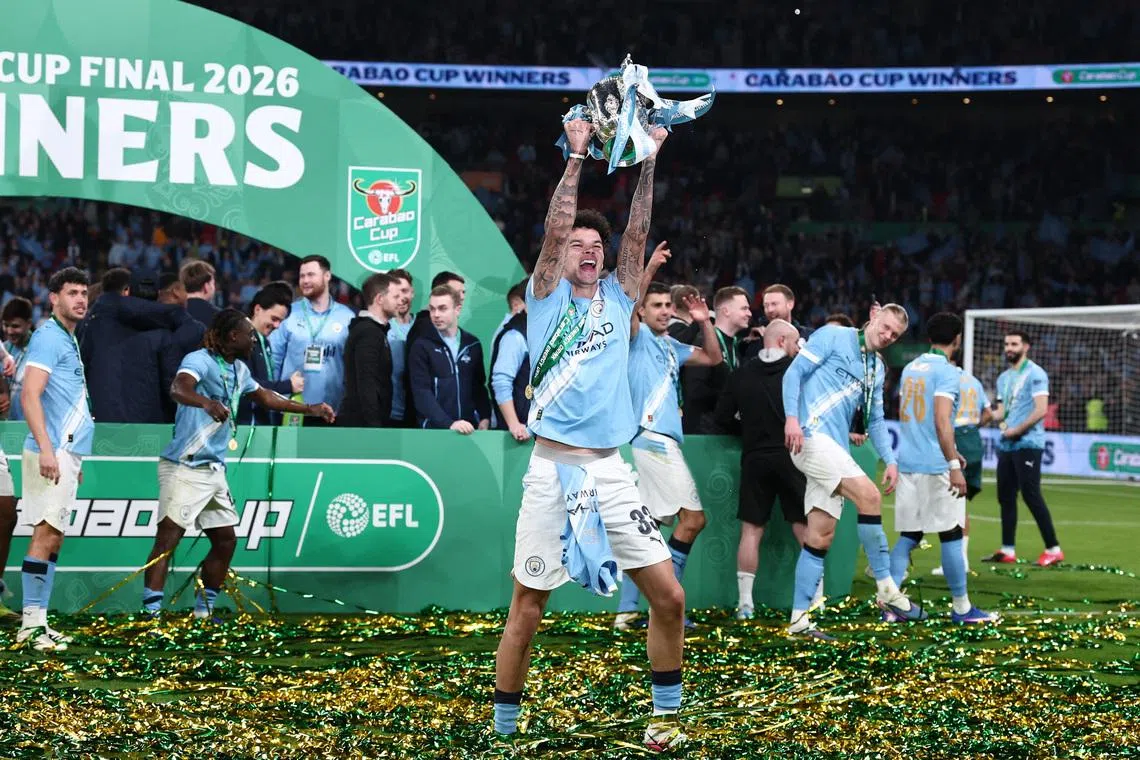 Soccer Football - Carabao Cup - Final - Arsenal v Manchester City - Wembley Stadium, London, Britain - March 22, 2026 Manchester City's Nico O'Reilly celebrates with the trophy after winning the Carabao Cup REUTERS/David Klein EDITORIAL USE ONLY. NO USE WITH UNAUTHORIZED AUDIO, VIDEO, DATA, FIXTURE LISTS, CLUB/LEAGUE LOGOS OR 'LIVE' SERVICES. ONLINE IN-MATCH USE LIMITED TO 120 IMAGES, NO VIDEO EMULATION. NO USE IN BETTING, GAMES OR SINGLE CLUB/LEAGUE/PLAYER PUBLICATIONS. PLEASE CONTACT YOUR ACCOUNT REPRESENTATIVE FOR FURTHER DETAILS..