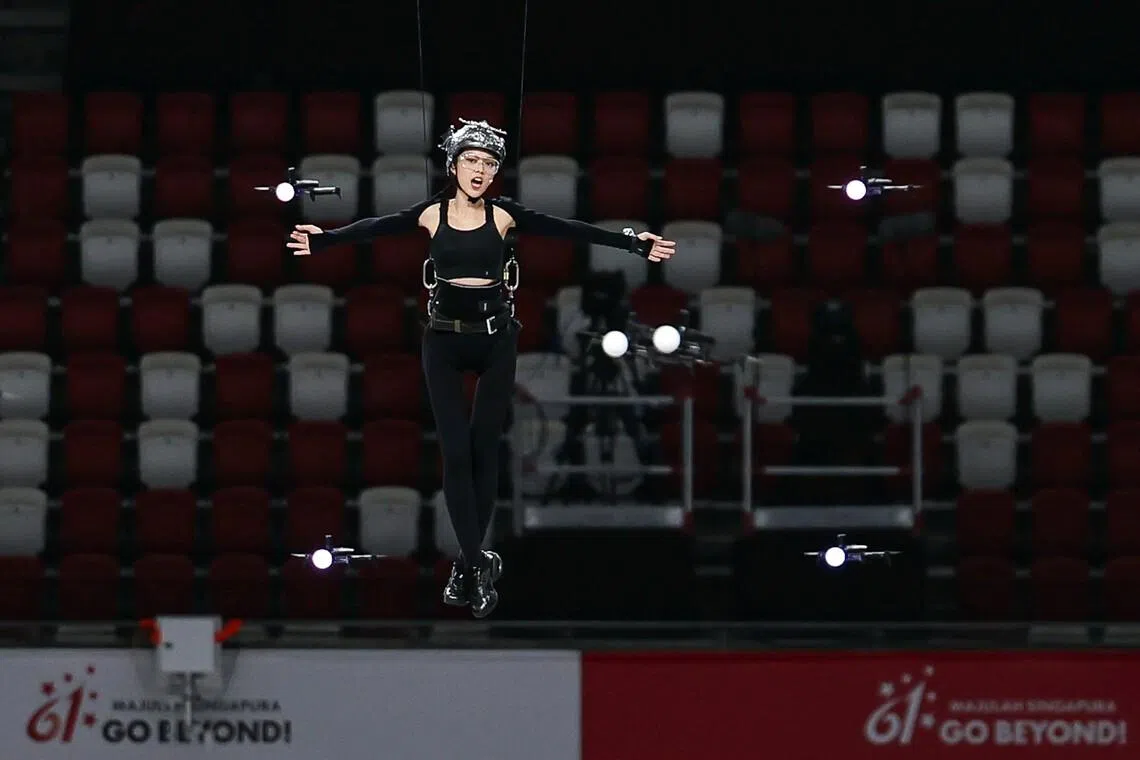 After each rehearsal, Sokko reviews footage of the drone formations and her fellow aerialists’ positioning to sharpen her own timing.