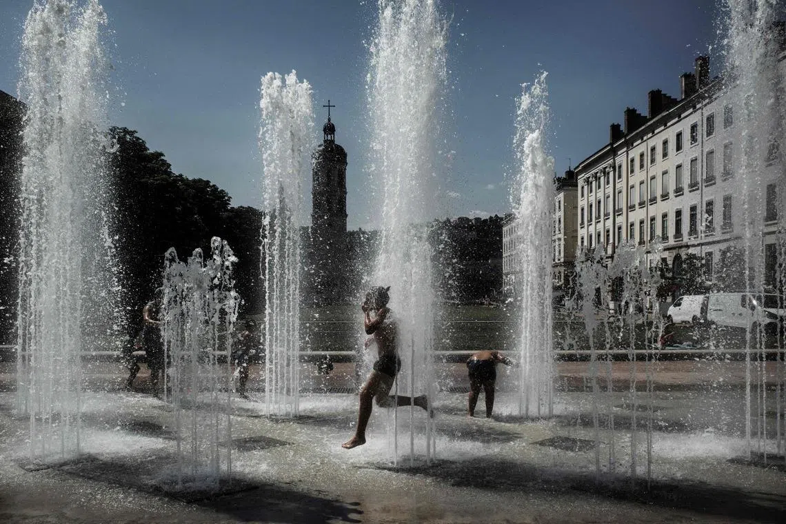 Children playing in a fountain in Lyon to cool off, on May 27, 2026 as a heatwave hits France. 