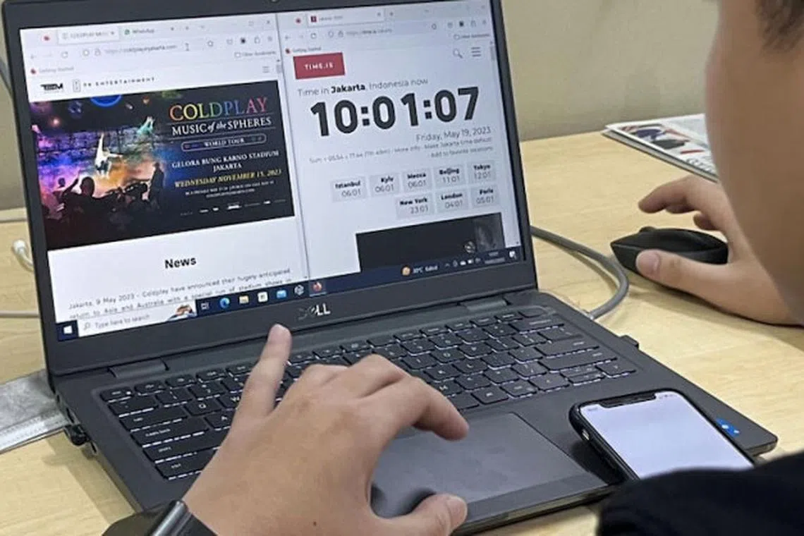 A man views the presale countdown timer to buy tickets for a Coldplay concert in Jakarta.