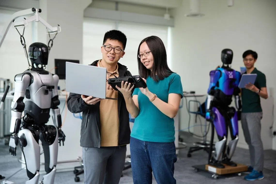 aw rui huan working with a colleague on an embodied ai project developing robots that can respond to natural language commands and carry out complex tasks, example work in science and technology careers at htx