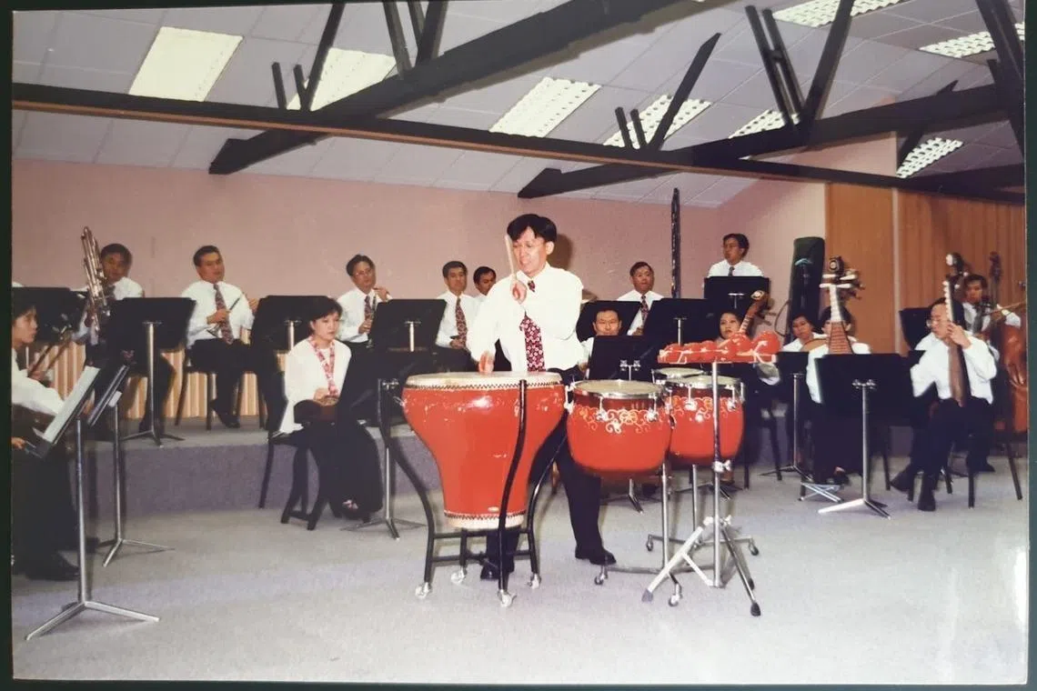 Quek Ling Kiong at an outreach concert at the People’s Association’s former headquarters at the Old Kallang Airport building in 1997.