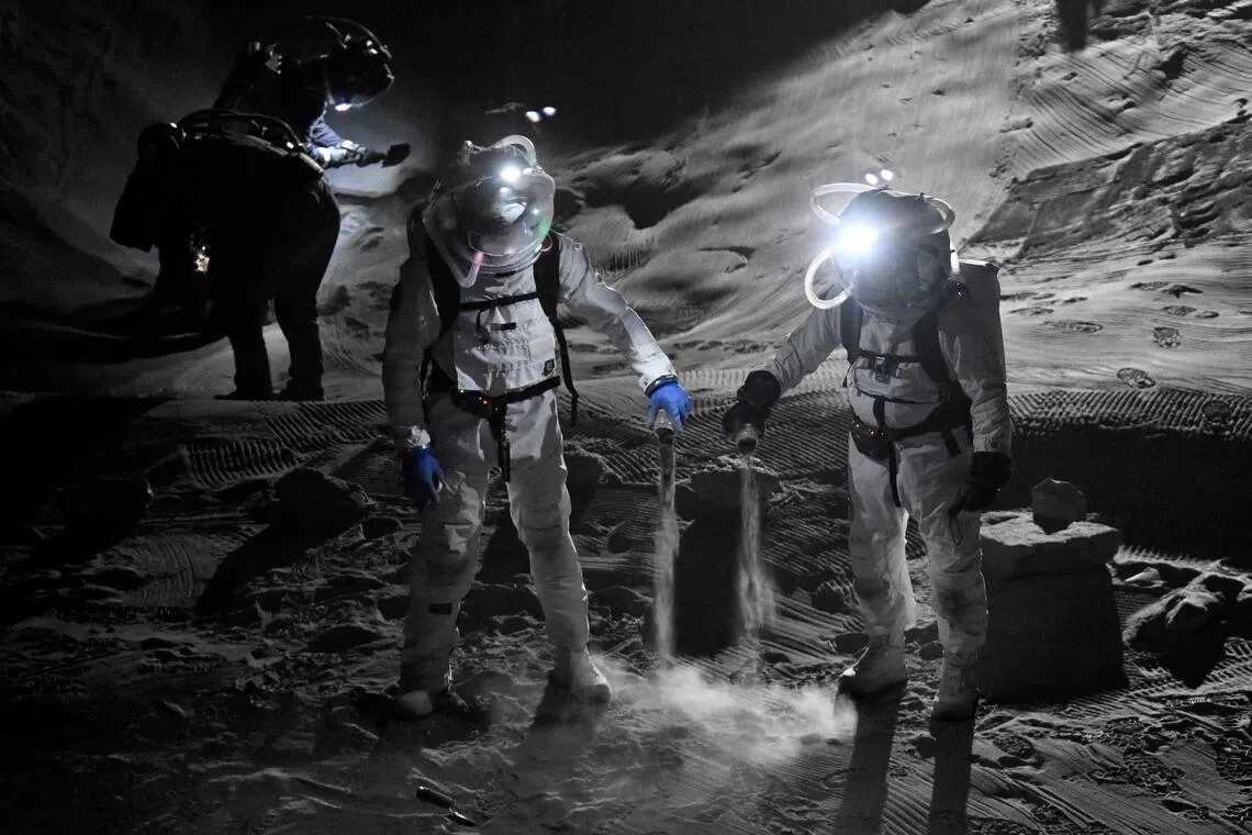 Scientists testing spacesuits during a press event on Sept 3 at a new lunar simulation facility in western Germany, called LUNA.