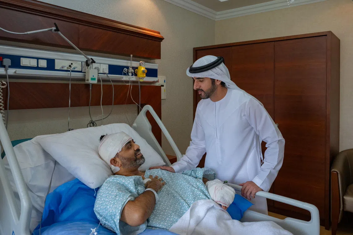 Hamdan bin Mohammed Al Maktoum (right), Crown Prince of Dubai, meets Captain Smit Machchhar, who is under treatment after he was stabbed by a co-pilot.