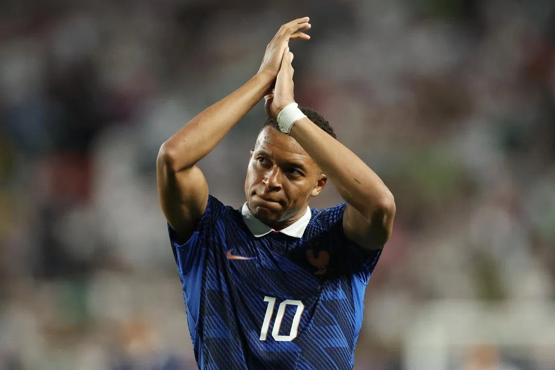 Kylian Mbappe double sends France into knockout rounds after lengthy weather delay