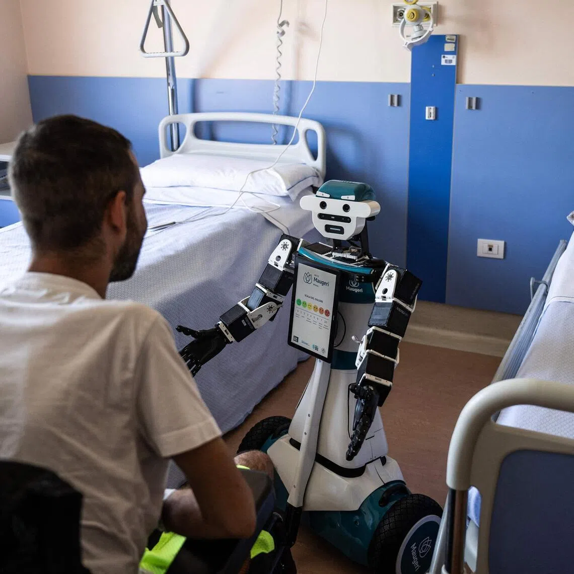 Humanoid robot Alter-Ego assisting a patient at the Maugeri Hospital in Milan on June 12.