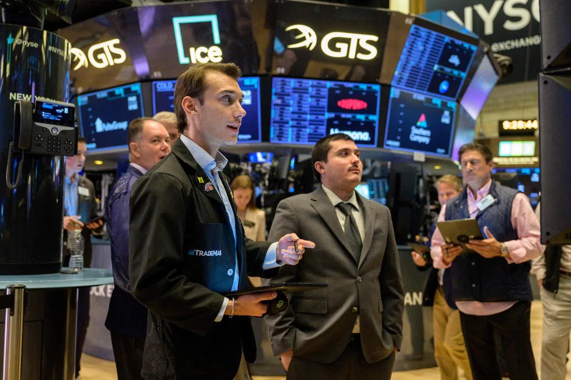 Traders work on the floor of the New York Stock Exchange, during opening bell, in New York City.