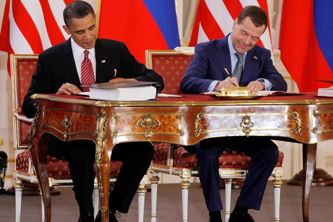 FILE PHOTO: Barack Obama (L) and Dmitry Medvedev, who were then the U.S. and Russian presidents, sign the new Strategic Arms Reduction Treaty (START II) at Prague Castle in Prague April 8, 2010. REUTERS/Jason Reed/File Photo