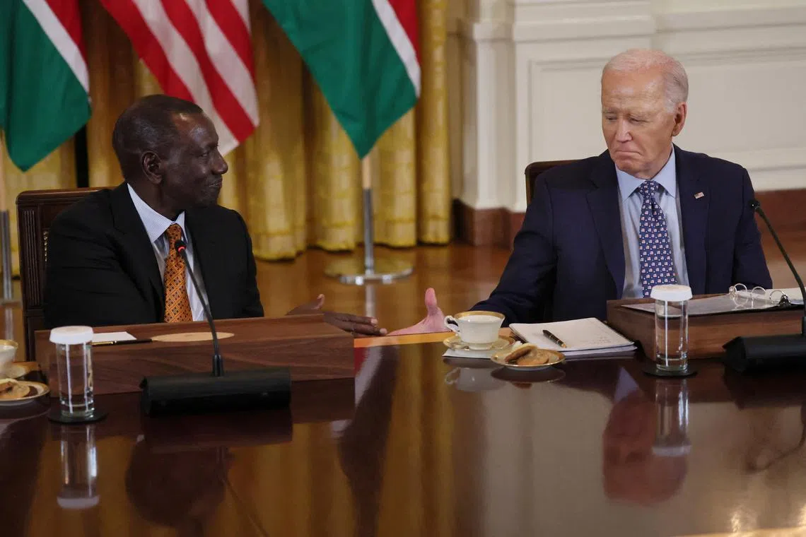 U.S. President Joe Biden goes in for a handshake during event with Kenyan President William Ruto and business executives at the White House, in Washington, U.S., May 22, 2024. REUTERS/Leah Millis