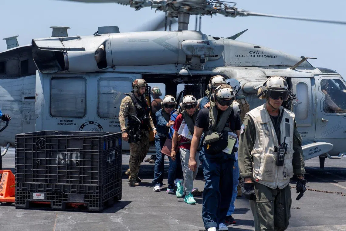 Sailors from the Dwight D. Eisenhower Carrier Strike Group assist distressed mariners rescued from the Liberian-flagged, Greek-owned bulk carrier M/V Tutor that was attacked by Houthis, in the Red Sea, on June 15.
