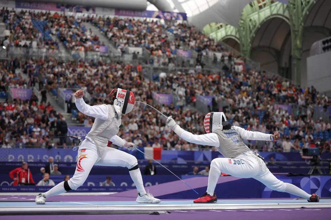 Singaporean fencer Amita Berthier (left) lost 15-13 to the United States' world No. 9 Lauren Scruggs at the Grand Palais in Paris, France on July 28.