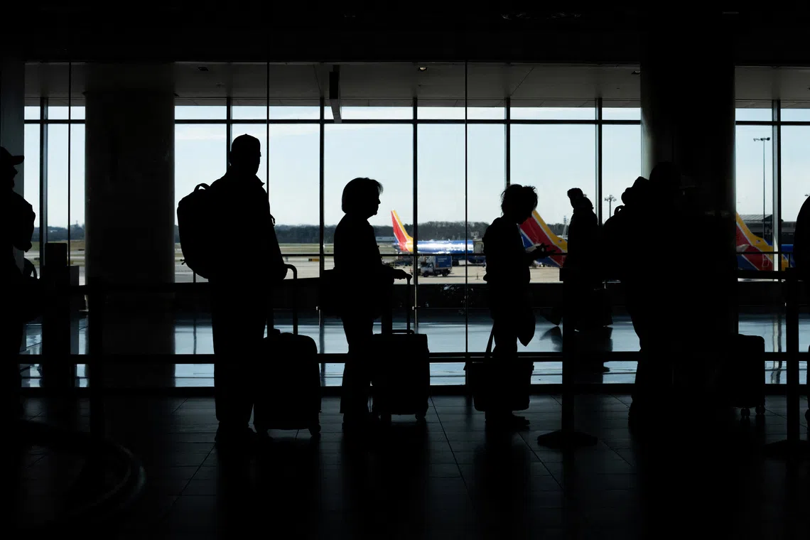 FILE PHOTO: Passengers wait in a TSA security checkpoint queue that stretches through Baltimore/Washington International Thurgood Marshall Airport (BWI) in Baltimore, Maryland., U.S., March 29, 2026. REUTERS/Aaron Schwartz/File Photo