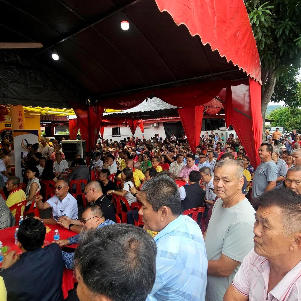 Villagers attending an event in Jementah, Johor, on June 24, where Transport Minister Anthony Loke marked the completion of a solar panel installation with a symbolic cheque presentation.