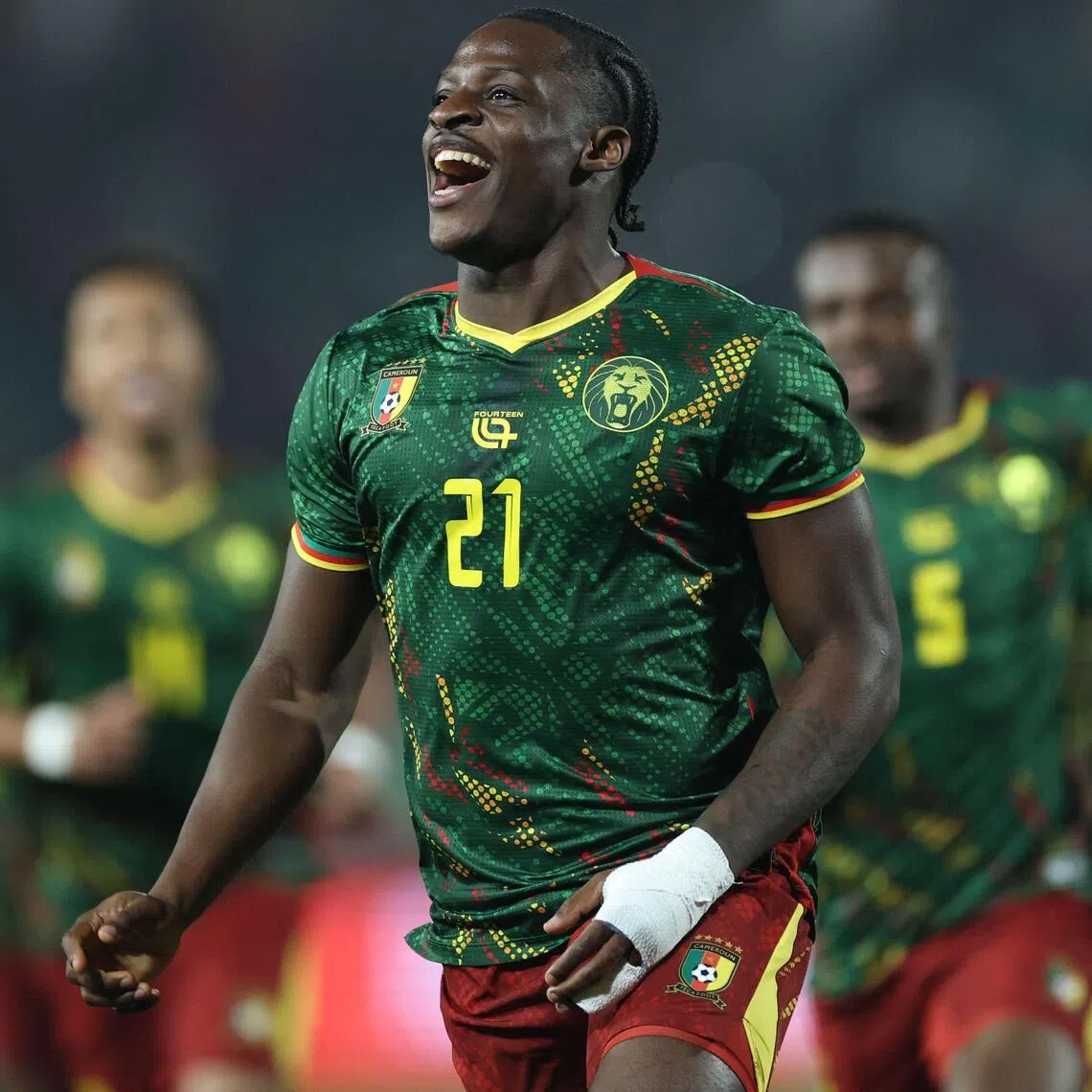 Cameroon's forward #21 Karl Etta Eyong celebrates scoring the team's first goal during the Africa Cup of Nations (CAN) Group F football match between Cameroon and Gabon at Adrar Stadium in Agadir on December 24, 2025. (Photo by FRANCK FIFE / AFP)