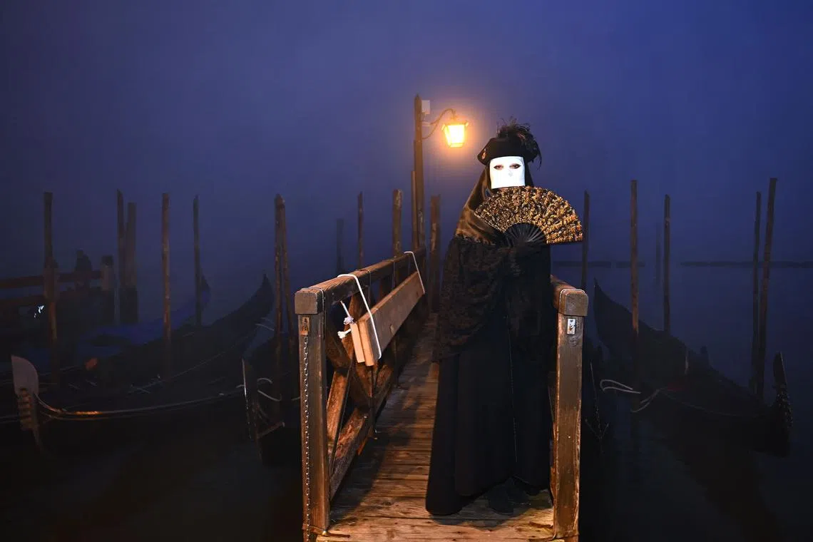 A masked reveller wearing a period costume posing during the pre-opening of the carnival in Venice on Jan 27, 2024. The 2024 Venice Carnival will take place from Feb 3 to 13, and will celebrate Marco Polo's Amazing Journey. 