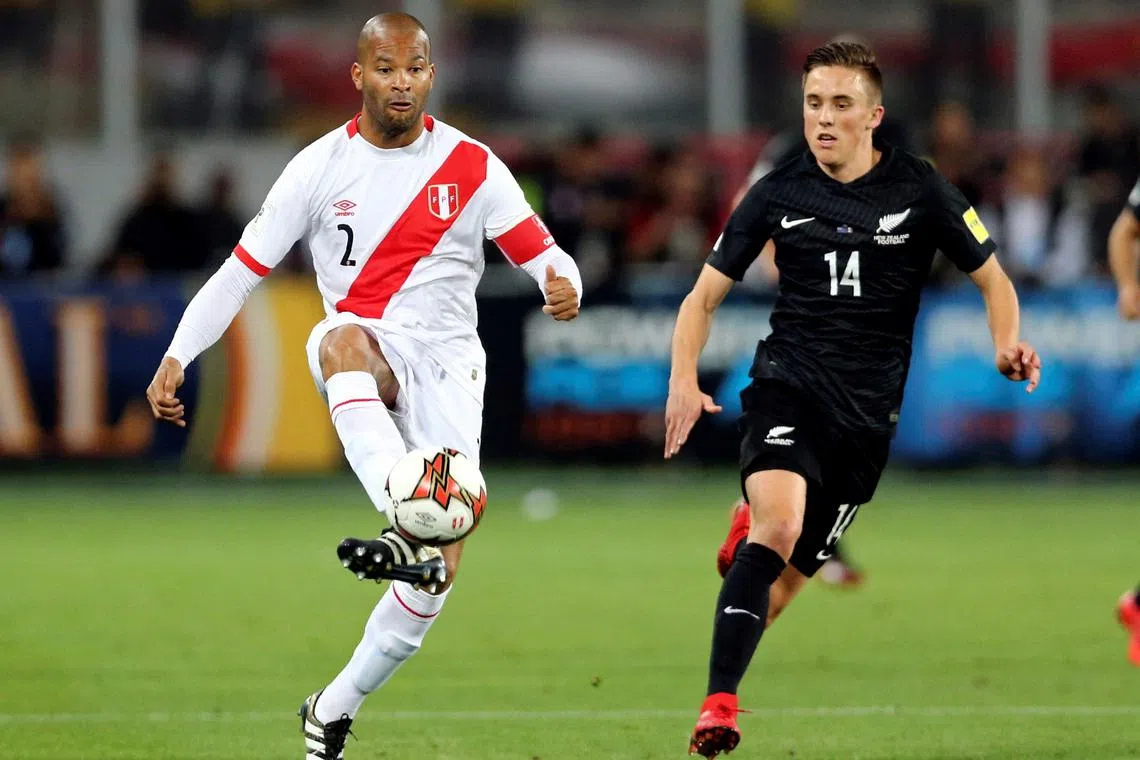 FILE PHOTO: Soccer Football - Peru v New Zealand - 2018 World Cup Qualifying Playoffs - National Stadium, Lima, Peru - November 15, 2017. Peru's Alberto Rodriguez and New Zealand's Ryan Thomas fight for the ball. REUTERS/Mariana Bazo/File Photo