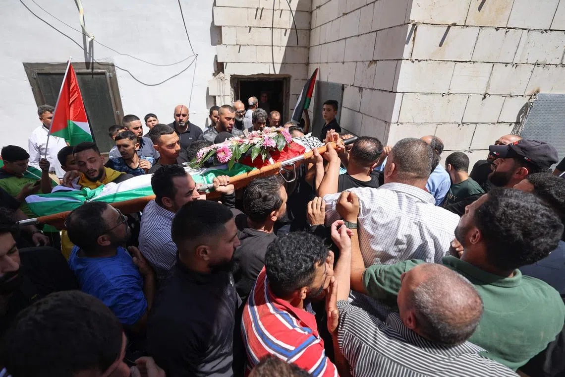 Mourners carrying the body of Palestinian Qusai Jamal Maatan during his funeral in the village of Burqa on Aug 5.
