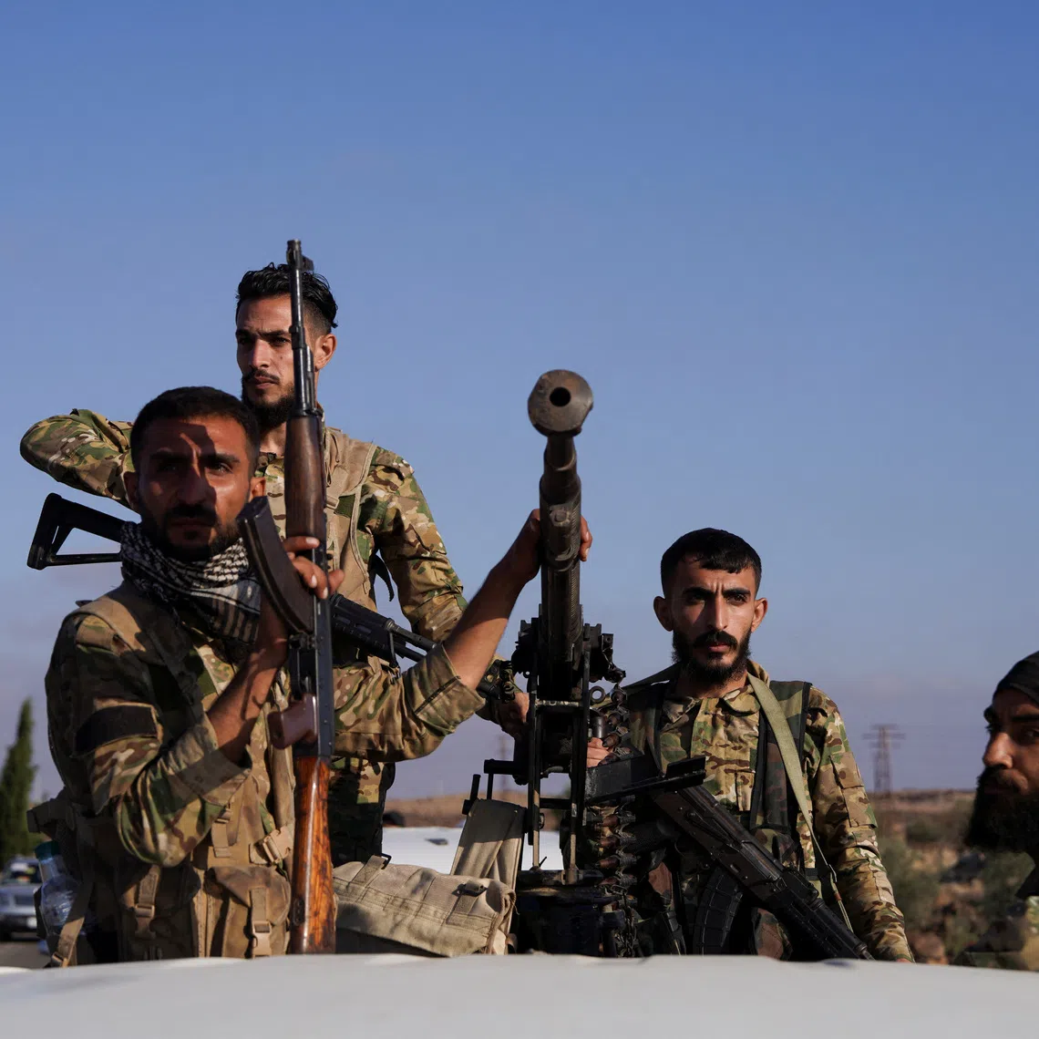 Members of Syrian security forces ride on a back of a truck in Druze city in Sweida, Syria July 15, 2025. REUTERS/Karam al-Masri/File Photo