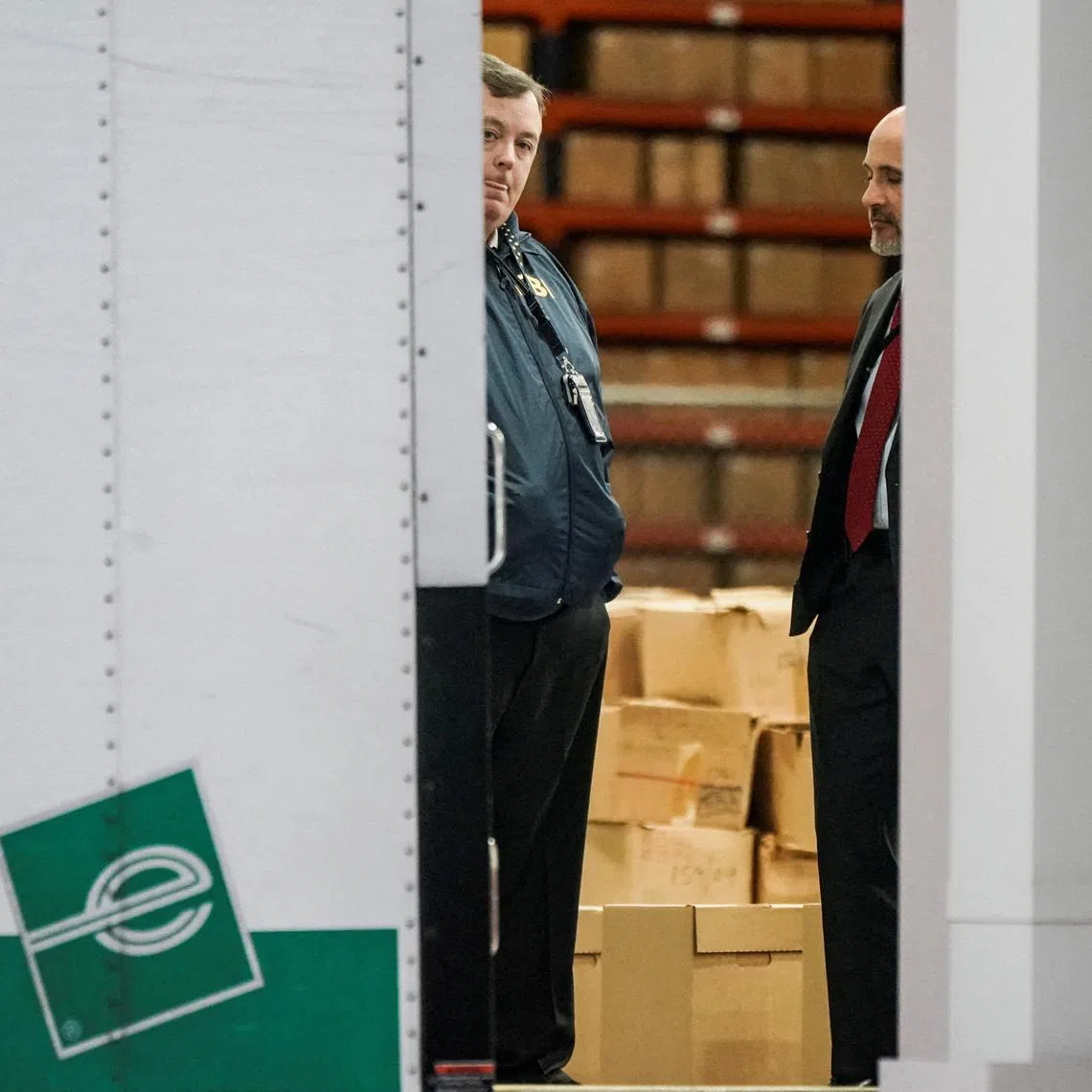 FILE PHOTO: Members of the Federal Bureau of Investigation (FBI) stand inside a vehicle loaded with boxes outside the Fulton County Election Hub and Operation Center after the FBI executed a search warrant there in relation to the 2020 election, according to a law enforcement official familiar with the matter, in Union City, Georgia, U.S. January 28, 2026.  REUTERS/Elijah Nouvelage/File Photo
