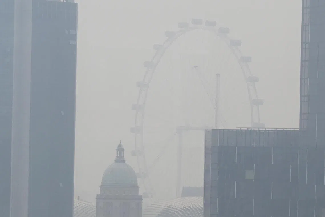 The Singapore Flyer shrouded in haze as seen from Robertson Quay at about 10am on Sept 14, 2026. 

The 24 hr PSI in the South is 81

ST PHOTO: Chong Jun Liang