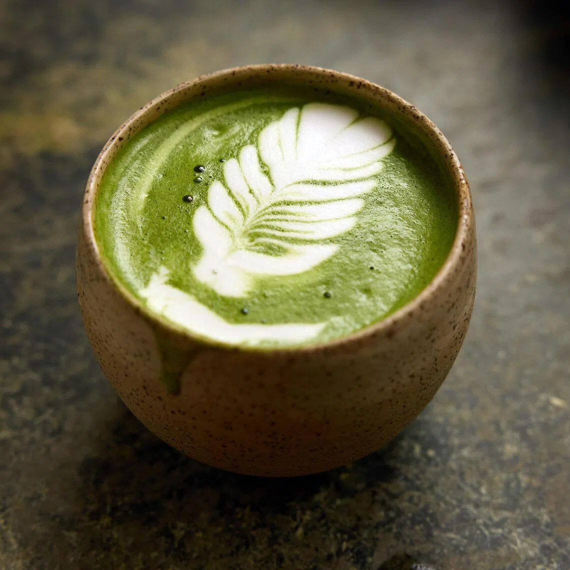 HEADLINE: Maybe Too Much Matcha
CAPTION: A matcha latte at Kettl, which sells Japanese tea at its store, in Brooklyn, Oct. 8, 2025. Once consumed mainly in small, formal tea ceremonies, matcha is now mixed into fruity lattes and preyed on by counterfeiters. 
CREDIT: (Colin Clark/The New York Times)