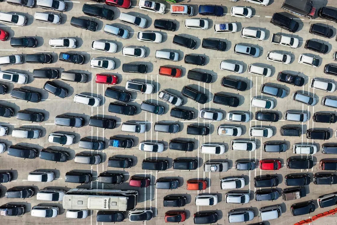 TOPSHOT - This aerial picture shows vehicles stuck in a traffic jam on the freeway heading out of Jakarta at a toll booth in Cikampek, West Java, on March 17, 2026, as people are heading to their hometowns for the upcoming Eid al-Fitr festivities, which marks the end of the Muslim's holy fasting month of Ramadan. (Photo by BAY ISMOYO / AFP)