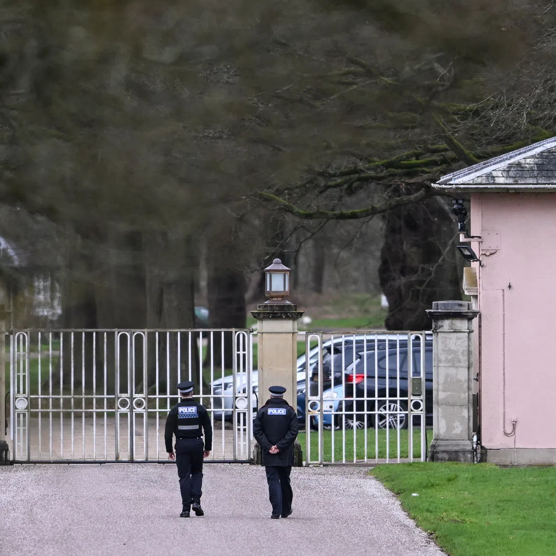Police officers at the entrance of the Royal Lodge, a property on the estate surrounding Windsor Castle and a former residence of Andrew Mountbatten-Windsor, younger brother of Britain's King Charles, formerly known as Prince Andrew, in Windsor, Britain, February 20, 2026. REUTERS/Jaimi Joy/File Photo