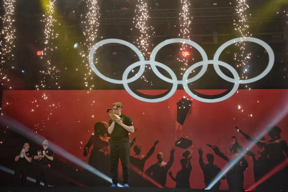 Frenchman Kylian Drumont celebrating winning the Gran Turismo 7 motorsport event at the Olympic Esports Week.