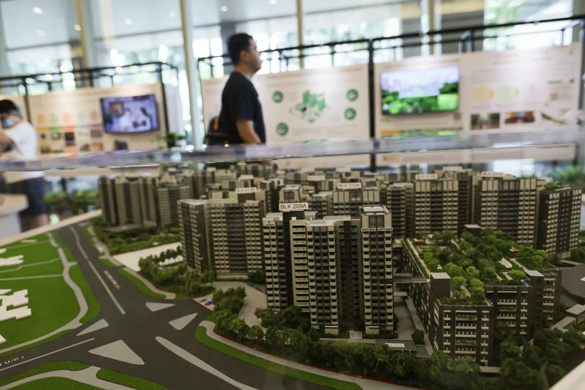 Generic photo of people looking at exhibits of BTO flats at HDB hub.