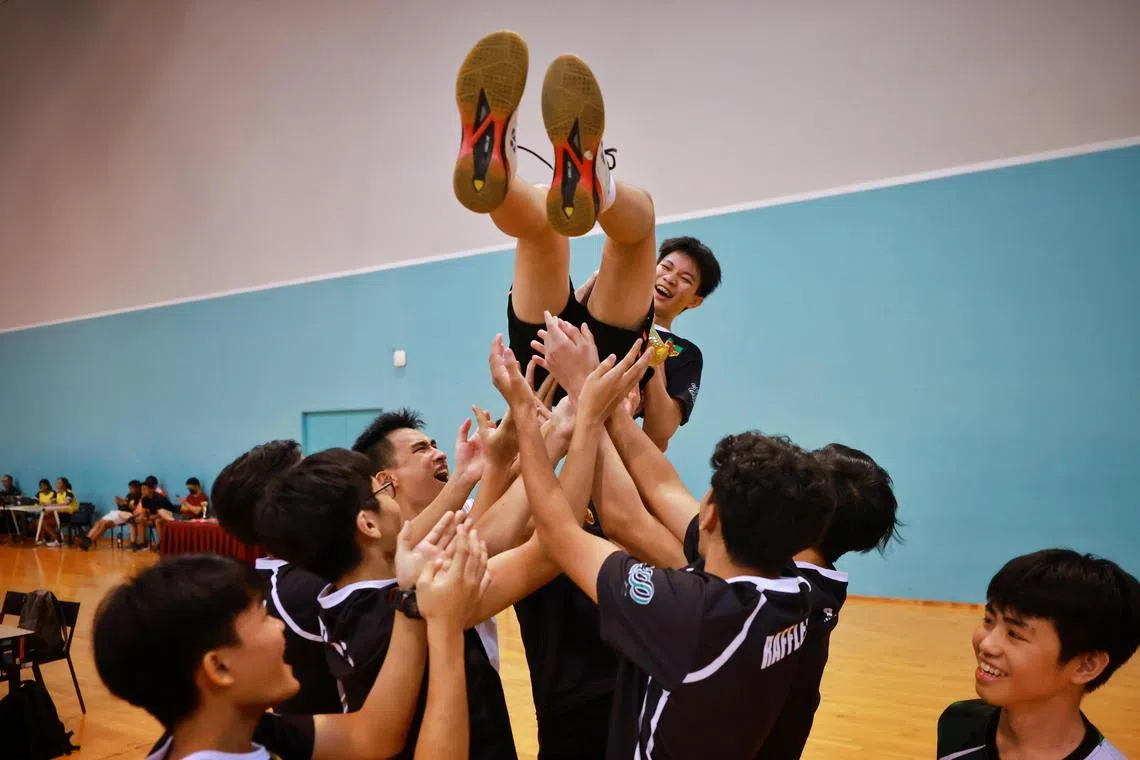 Raffles Institution’s Nixon Yap is hoisted into the air by his teammates after they defeated ACS(I) in the A Division boys' badminton final at OCBC Arena on May 17, 2023.

ST PHOTO: JASON QUAH