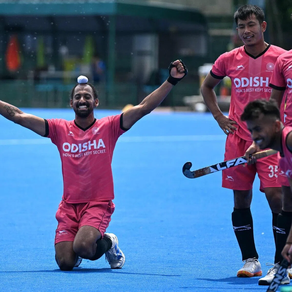 Hardik Singh (left) of the Indian men’s national hockey team cheering with teammates during a practice session at the Sports Authority of India (SAI) centre in Bengaluru.