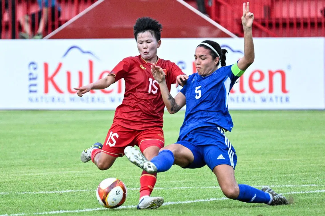 Vietnam's Nguyen Thi Bich Thuy and Philippines' captain Hali Long fighting for the ball during the women's football match between Vietnam and Philippines at RSN Stadium during the 32nd SEA Games in Phnom Penh on May 9.