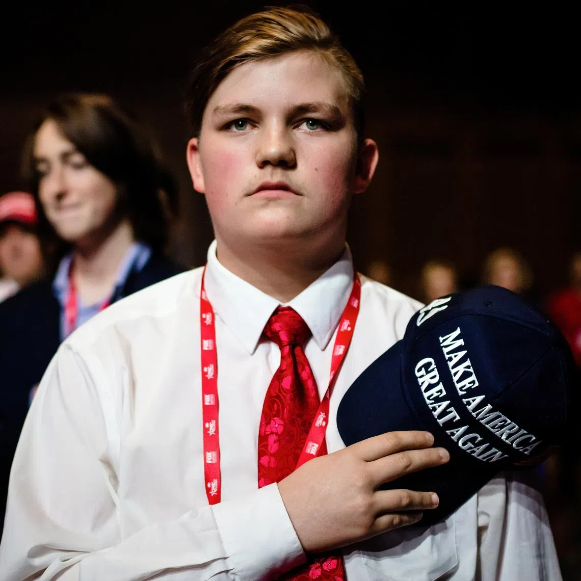A young attendee during the Pledge of Allegiance at a meeting of the Conservative Political Action Conference in Orlando on Feb 26, 2022.