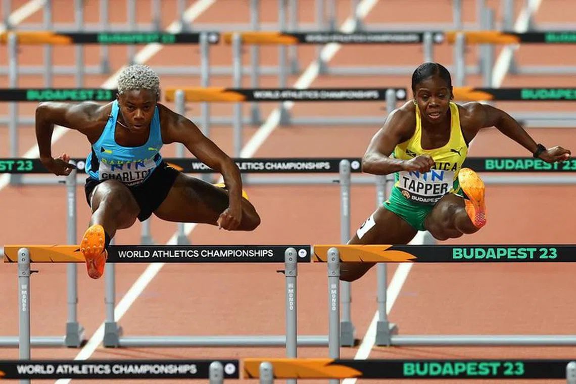 FILE PHOTO: Athletics - World Athletics Championship - Women's 100m Hurdles - National Athletics Centre, Budapest, Hungary - August 23, 2023 Bahamas' Devynne Charlton and Jamaica's Megan Tapper in action during heat 1 REUTERS/Bernadett Szabo/File Photo