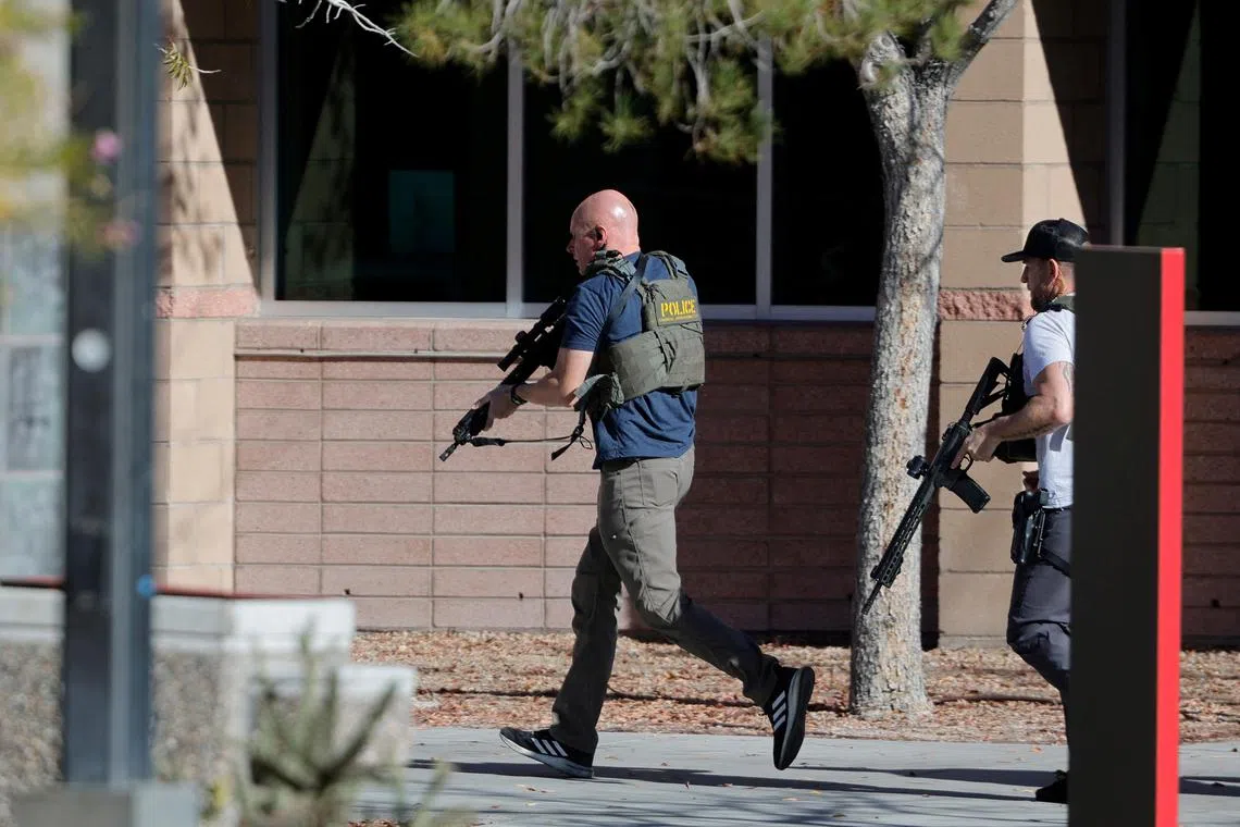 Law enforcement officers head into the UNLV campus after reports of an active shooter.