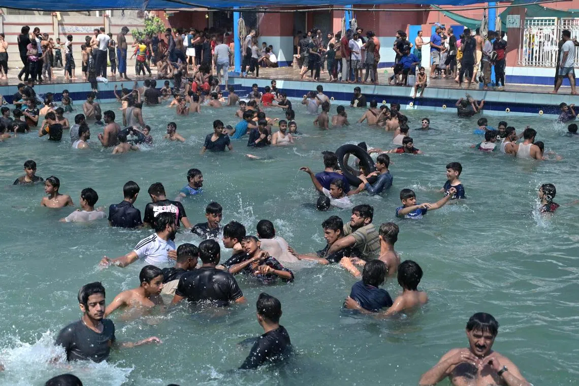 People cooling off in a swimming pool to beat the heat in Lahore, Pakistan, on May 26.