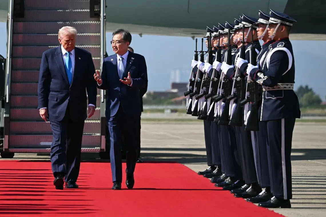 US President Donald Trump is greeted by South Korea's Foreign Mister Cho Hyun upon his arrival at the airport in Gyeongju on Oct 29.