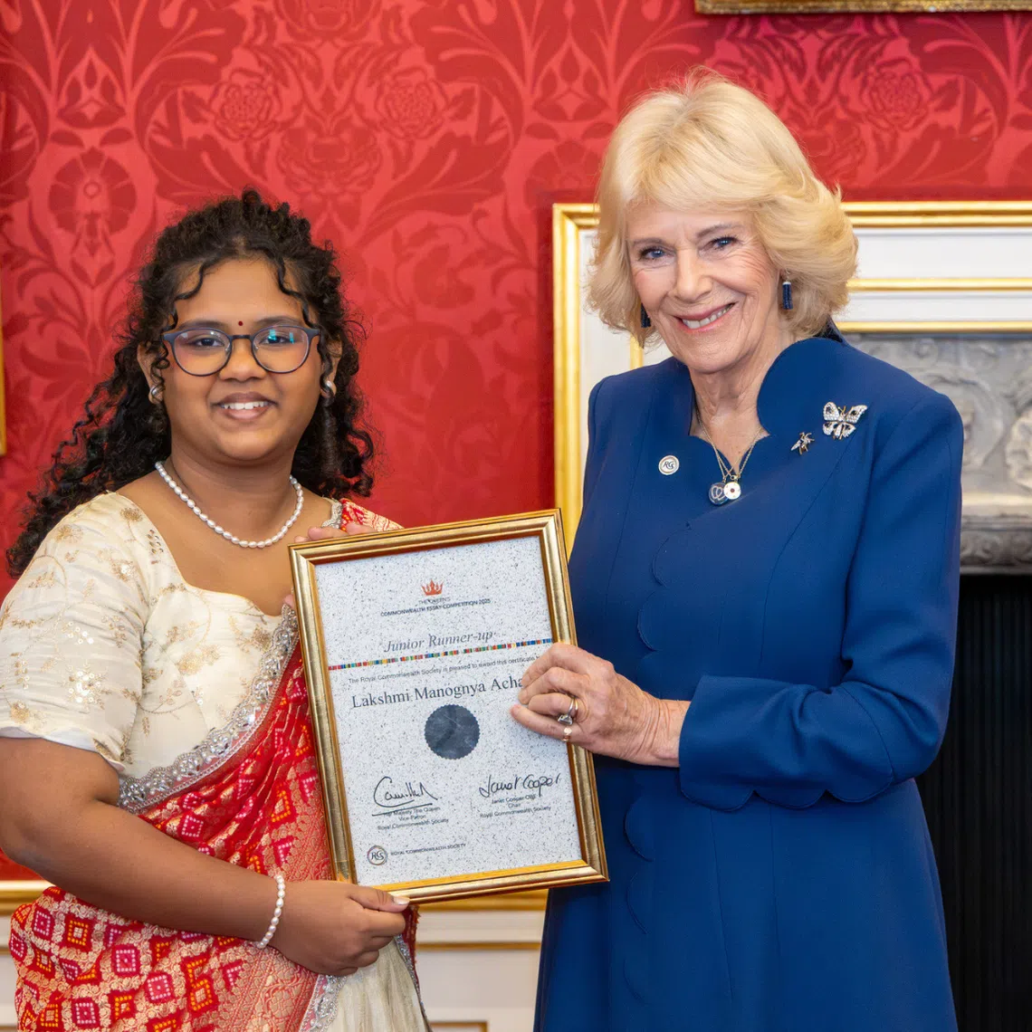 Lakshmi Manognya Achanta receiving her junior runner-up certificate from Britain's Queen Camilla on Nov 20.