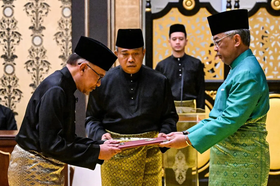 Datuk Seri Anwar Ibrahim (left) being sworn in as prime minister in front of Malaysia’s King Sultan Abdullah Sultan Ahmad Shah on Nov 24.