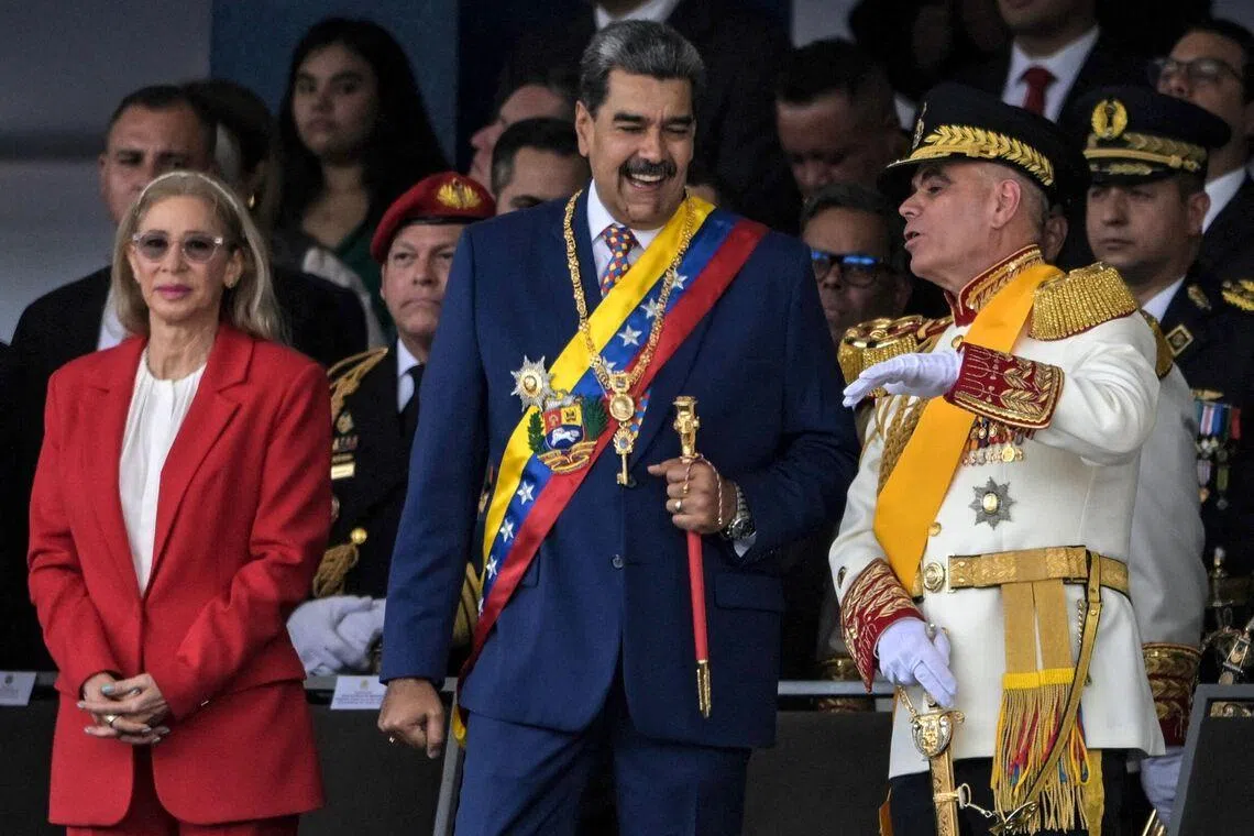 Venezuela's President Nicolas Maduro (centre), First Lady Cilia Flores and Defence Minister Vladimir Padrino Lopez during Independence Day celebrations in Caracas on July 5, 2025. 