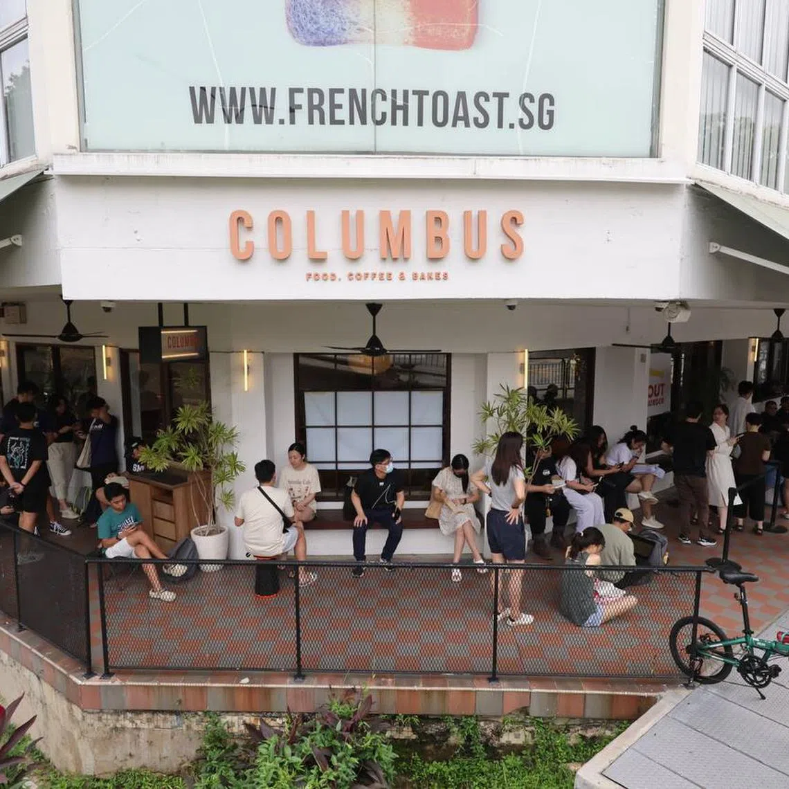 Customers wait in line at Columbus Cafe Co., at Upper Thomson, where the pop-up is held, on May 31.
