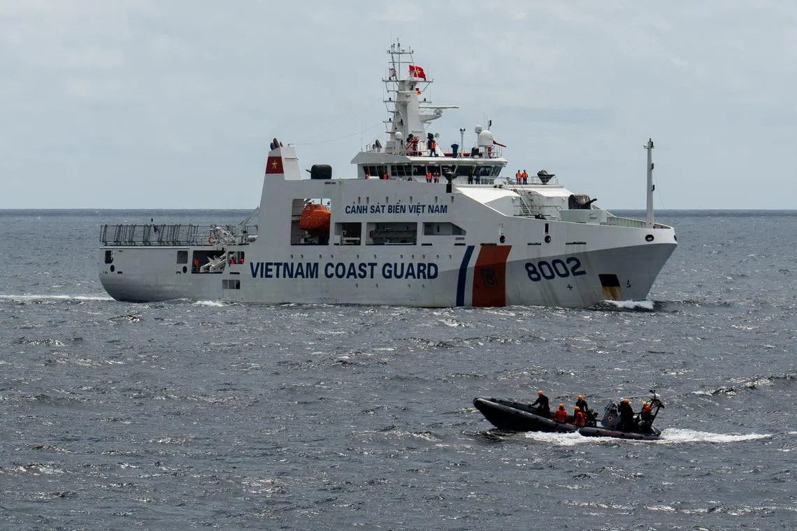 A Philippine Coast Guard boat passes by a Vietnamese Coast Guard ship during a joint maritime exercise between the Philippine Coast Guard and Vietnamese Coast Guard, in the waters of Bataan province, Philippines, August 9, 2024. REUTERS/Lisa Marie David
