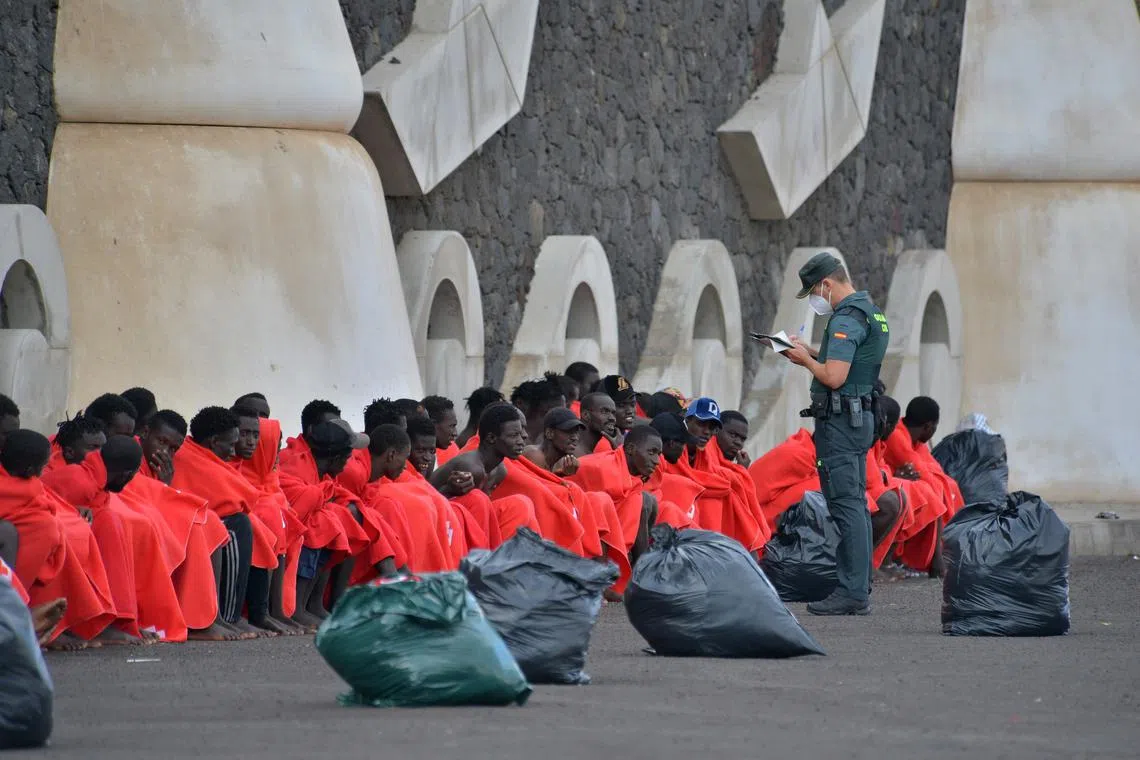 An officer checks 148 sub-Saharan immigrants that include 20 minors and eight women, after arriving at the port of La Restinga, El Hierro, Canary Island, Spain, on Oct 20, 2023.