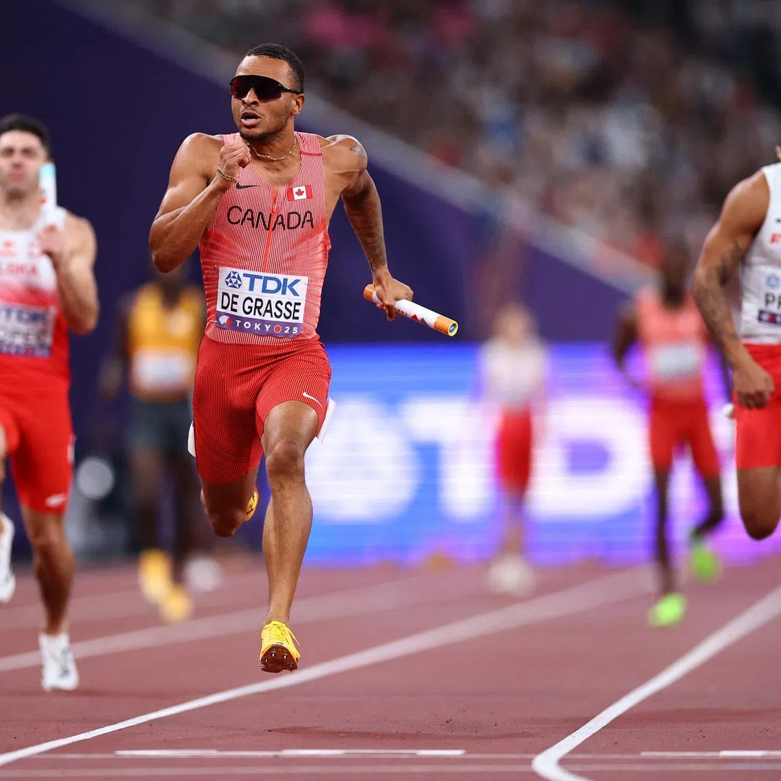 World Athletics Championships Tokyo 2025 - Men's 4 x 100m Relay Round 1 - Japan National Stadium, Tokyo, Japan - September 20, 2025 Canada's Andre De Grasse crosses the finish line to win heat 1. REUTERS/Sarah Meyssonnier